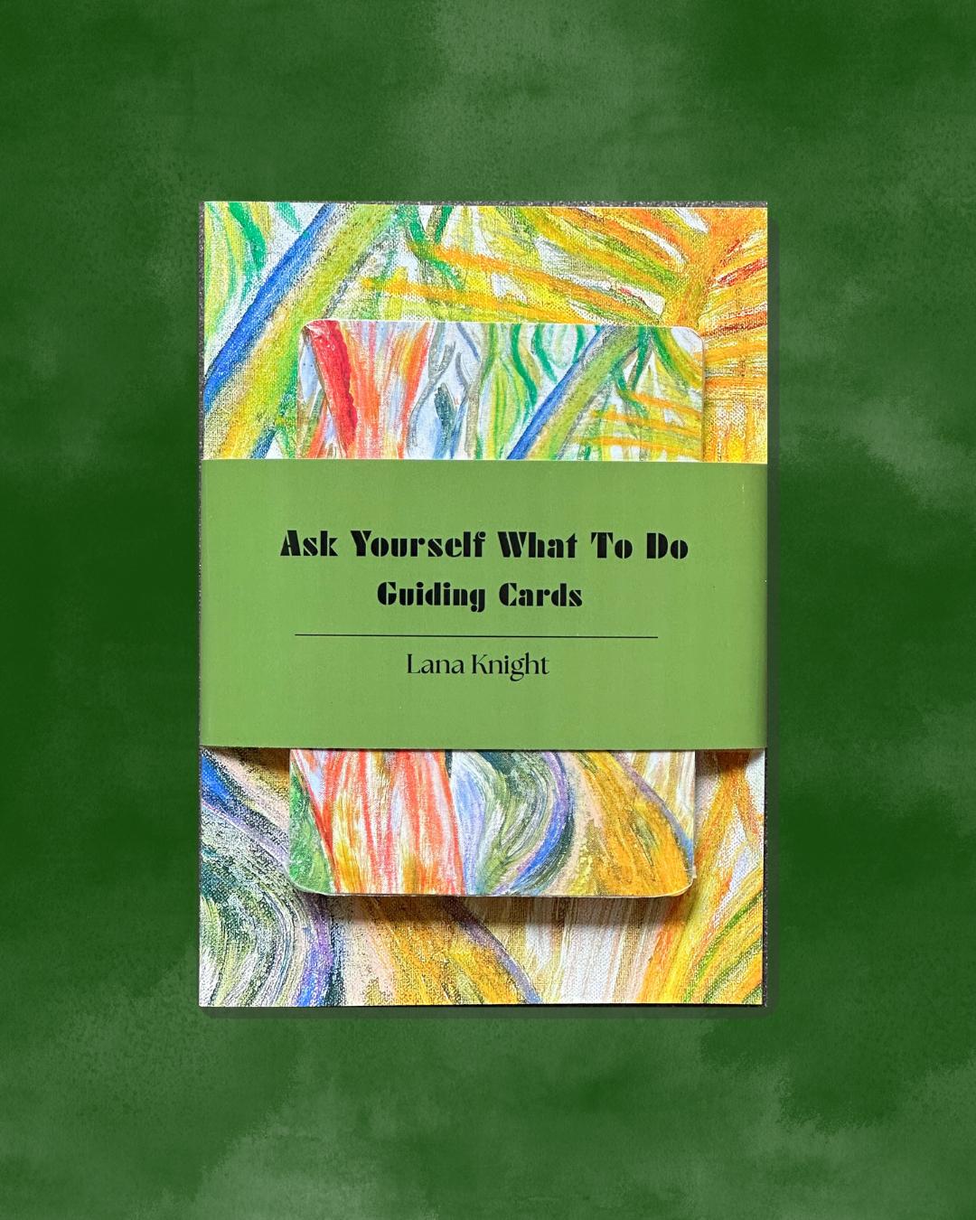 Ask Yourself What To Do Guiding Cards set by Lana Knight against a green backdrop. Card set cover is a colourful design with shades of green, red, orange and blue.